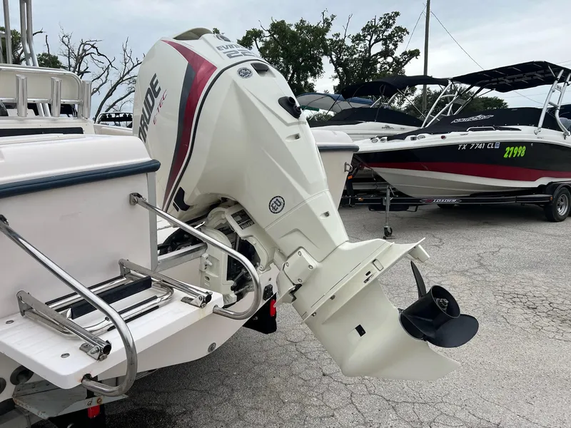 Slide: The Image of 1999 Grady-White 222 boat with Evinrude outboard motor, parked in a marina. - 4