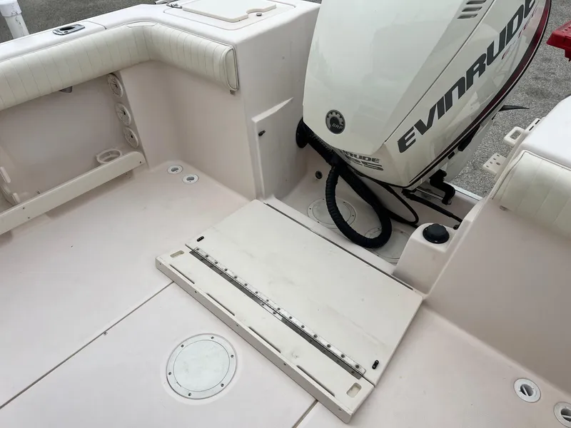 Slide: The Image of 1999 Grady-White 222 boat interior with Evinrude motor, featuring spacious seating and clean design. - 5