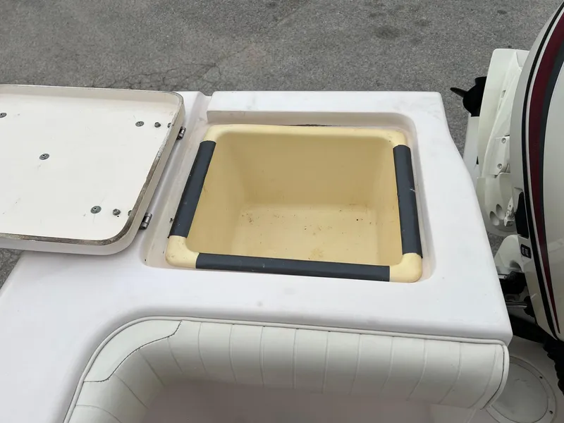 Slide: The Image of 1999 Grady-White 222 boat storage compartment with open lid, showcasing interior space. - 7