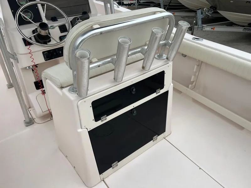Slide: The Image of 1999 Grady-White 222 boat interior with rod holders and steering wheel. - 9