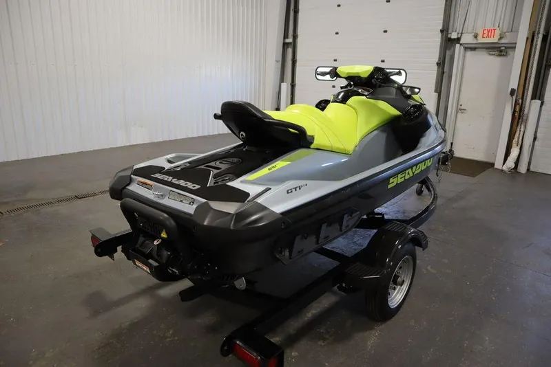 Slide: The Image of 2022 Sea-Doo GTI SE 170 SS jet ski on trailer in a garage. - 22