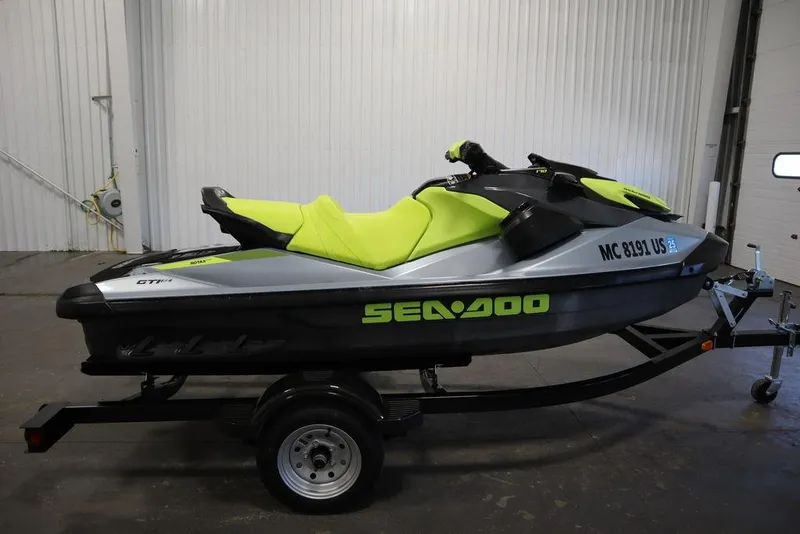 Slide: The Image of 2022 Sea-Doo GTI SE 170 SS jet ski with vibrant green seat on trailer. - 23