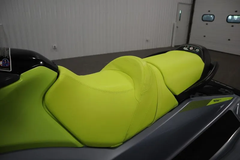 Slide: The Image of 2022 Sea-Doo GTI SE 170 SS with vibrant lime green seat in a garage setting. - 7