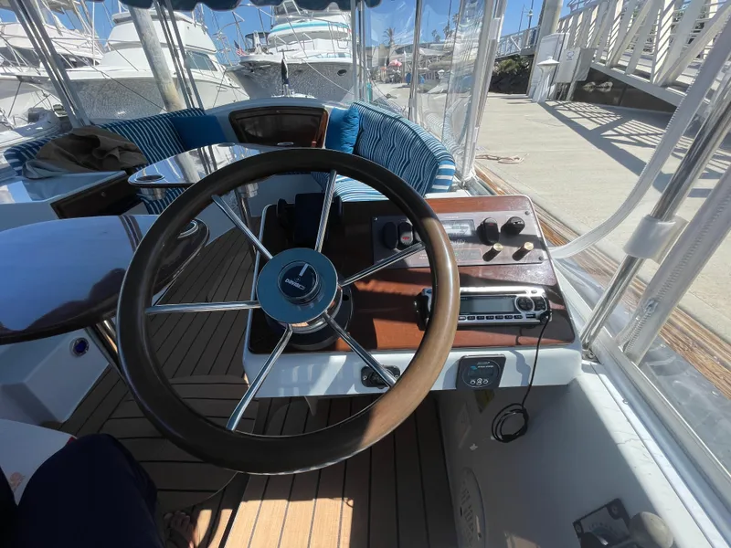 Slide: The Image of Steering wheel and dashboard of a 2014 Duffy 18 Snug Harbor boat at a marina. - 12