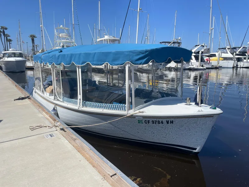 Slide: The Image of 2014 Duffy 18 Snug Harbor boat docked in marina with blue canopy. - 3