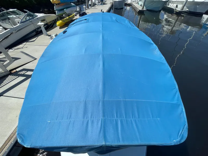 Slide: The Image of 2014 Duffy 18 Snug Harbor boat with blue cover docked at marina. - 5