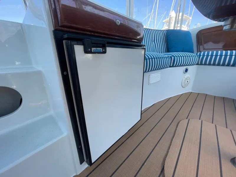 Slide: The Image of Interior of 2014 Duffy 18 Snug Harbor boat with seating and mini fridge. - 8