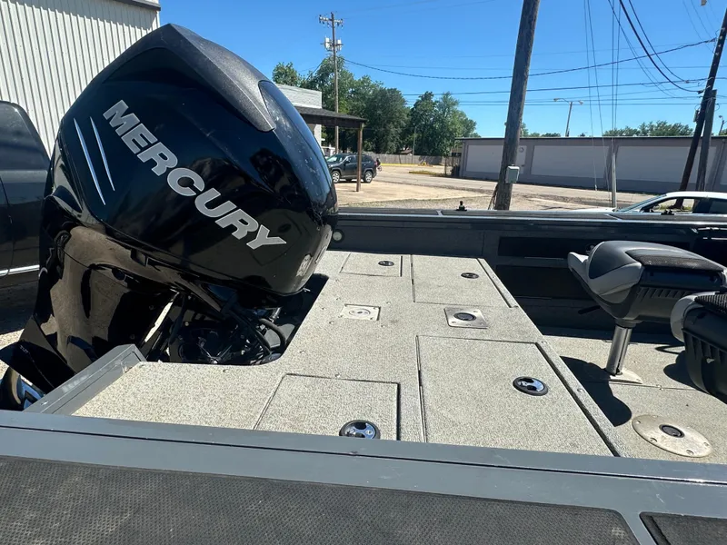 Slide: The Image of 2018 Tracker Targa V-19 WT boat with Mercury engine, featuring spacious deck and seating. - 10