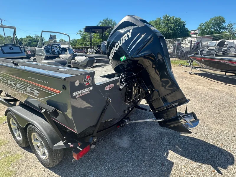 Slide: The Image of 2018 Tracker Targa V-19 WT boat with Mercury engine, parked on a trailer. - 12