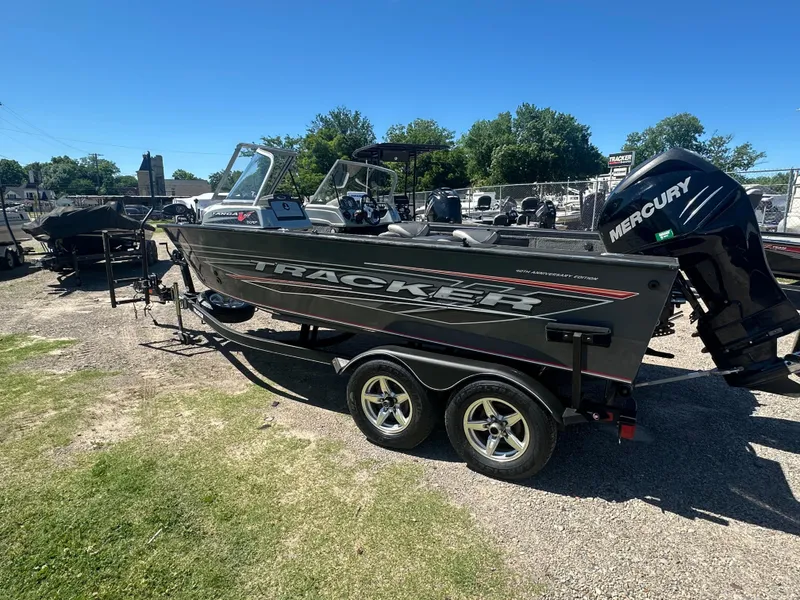 Slide: The Image of 2018 Tracker Targa V-19 WT 40th Anniversary Edition boat on trailer, outdoors. - 2
