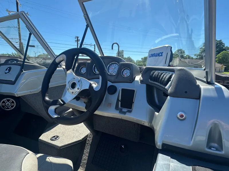 Slide: The Image of 2018 Tracker Targa V-19 WT boat dashboard with steering wheel and gauges. - 8