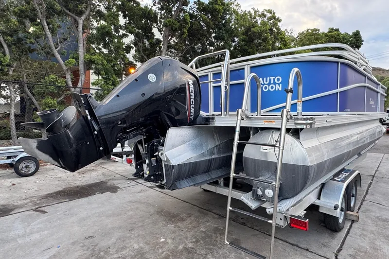 Slide: The Image of 2023 Barletta ARIA 22QC pontoon boat with Mercury outboard motor on trailer. - 14