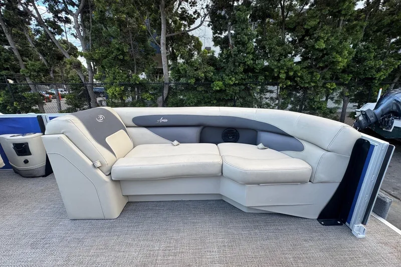 Slide: The Image of 2023 Barletta ARIA 22QC boat seating with plush beige upholstery and scenic background. - 21