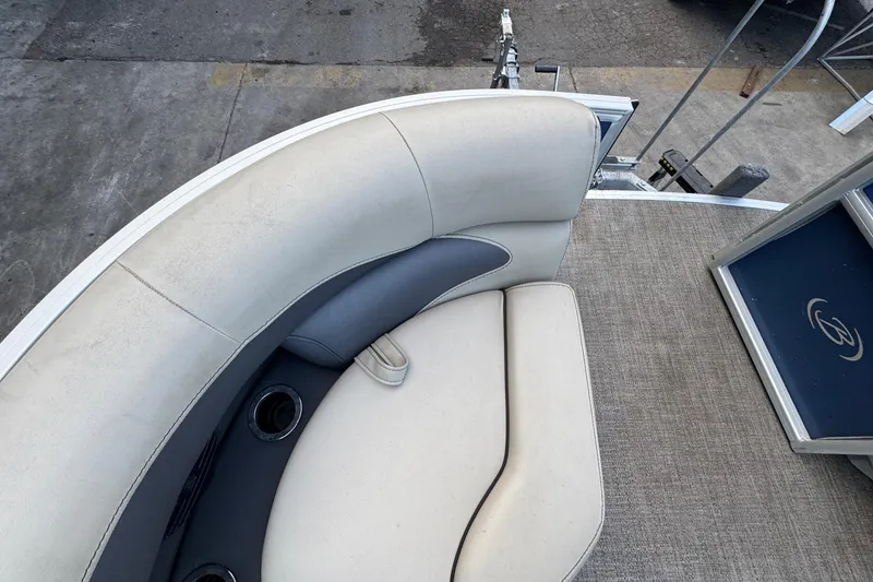 Slide: The Image of 2023 Barletta ARIA 22QC boat interior with cushioned seating and cup holders. - 23