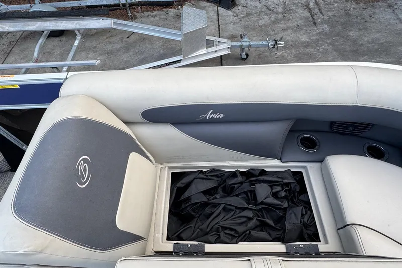 Slide: The Image of 2023 Barletta ARIA 22QC boat interior with storage compartment and cushioned seating. - 27