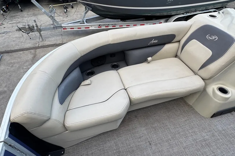 Slide: The Image of 2023 Barletta ARIA 22QC boat interior with plush seating and cup holders. - 30