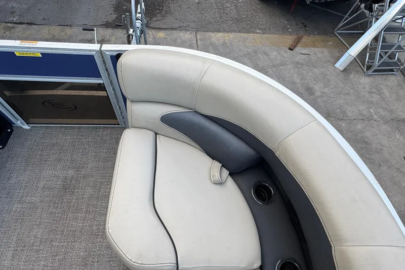 Slide: The Image of 2023 Barletta ARIA 22QC pontoon boat with beige and gray seating, cup holders visible. - 31