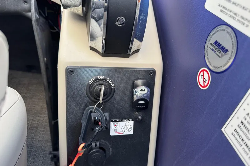 Slide: The Image of Control panel of 2023 Barletta ARIA 22QC boat with ignition key and canopy switch. - 48