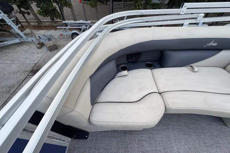 Slide: The Image of 2023 Barletta ARIA 22QC boat interior with cushioned seating and cup holders. - 57