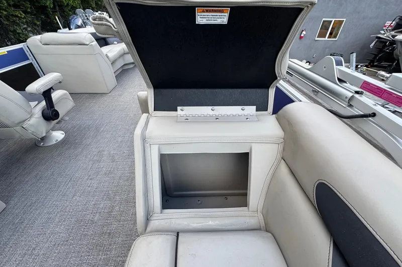 Slide: The Image of 2023 Barletta ARIA 22QC boat interior with open storage compartment and seating. - 62