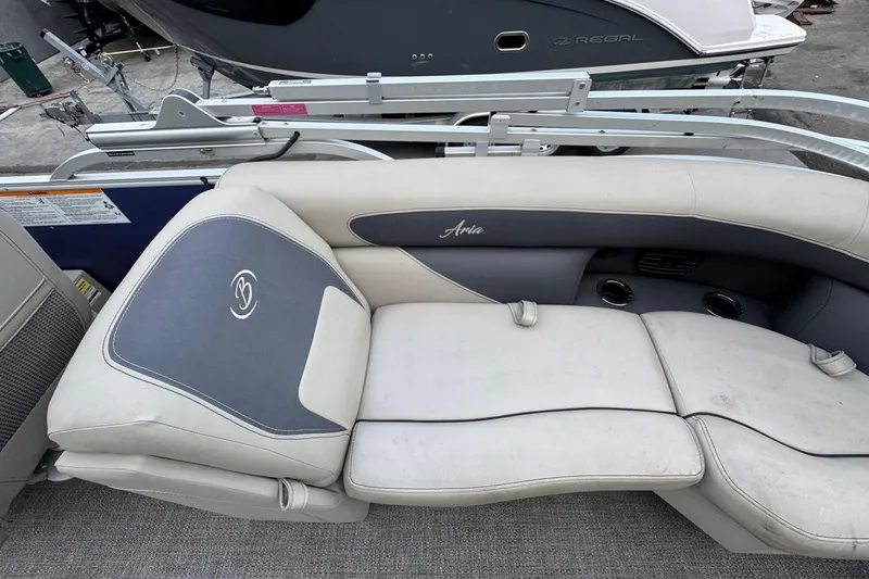 Slide: The Image of 2023 Barletta ARIA 22QC boat interior with cushioned seating and cup holders. - 63