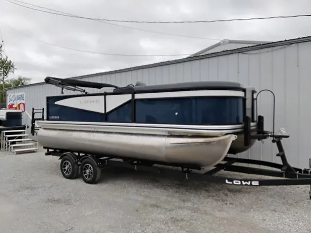 Slide: The Image of Pontoon boat Lowe LS 190 (2025) on a serene lake with people relaxing. - 1