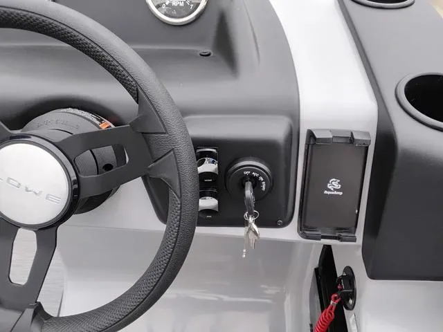 Slide: The Image of Steering wheel and dashboard of 2025 Lowe LS 190 boat with ignition keys. - 11