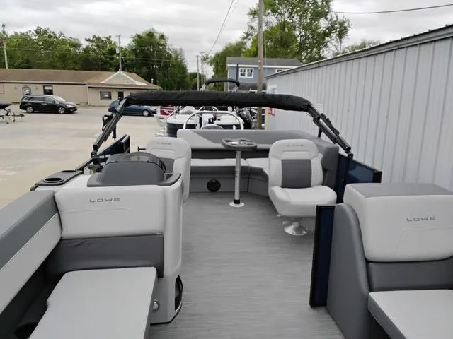 Slide: The Image of 2025 Lowe LS 190 pontoon boat with spacious seating and modern design. - 4