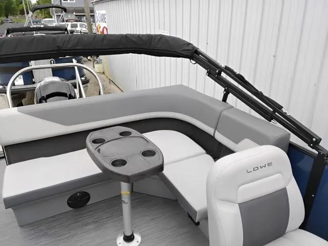 Slide: The Image of Lowe LS 190 boat interior, 2025 model, featuring gray seating and a central table. - 5