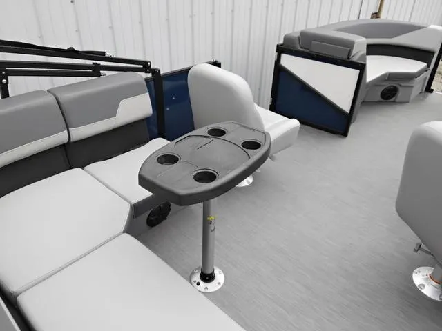 Slide: The Image of 2025 Lowe LS 190 boat interior with gray seating and cup holder table. - 9
