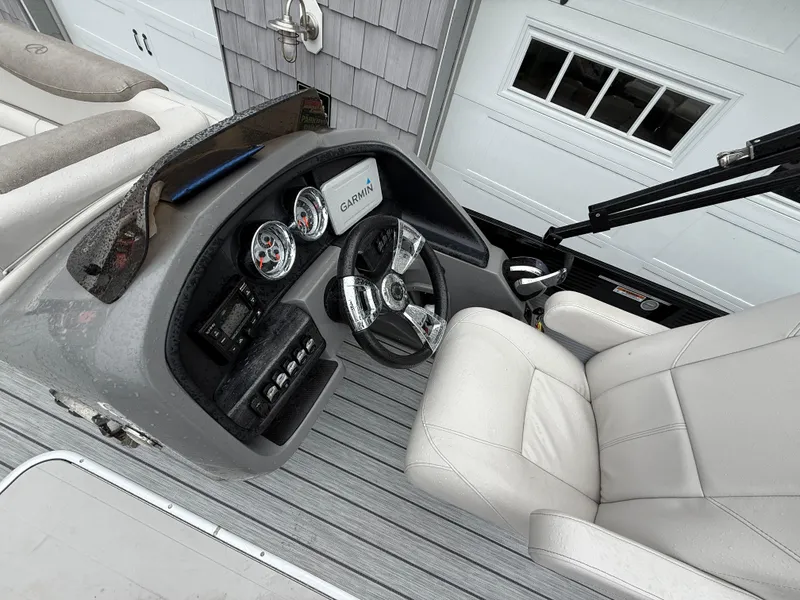 Slide: The Image of 2020 Avalon 2585 Catalina boat dashboard with steering wheel and Garmin display. - 17