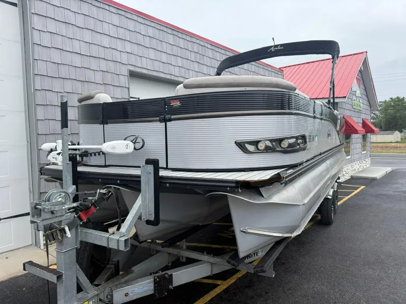 Slide: The Image of 2020 Avalon 2585 Catalina Rear Fish Tri-toon on trailer, parked outside a building. - 3