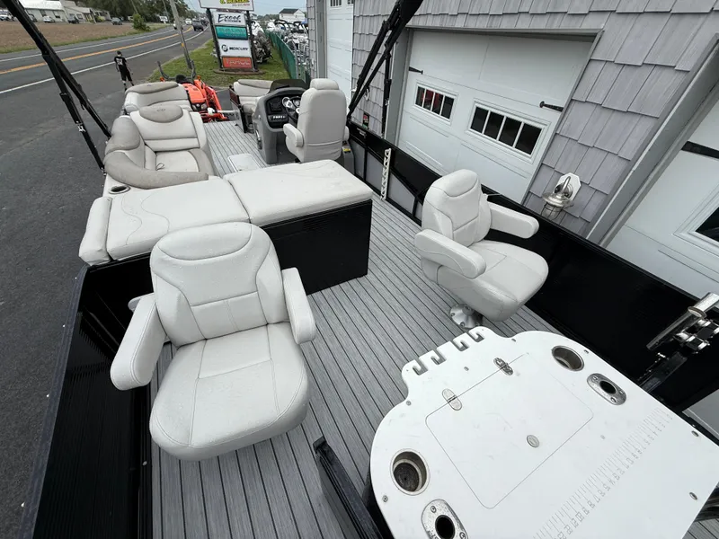 Slide: The Image of 2020 Avalon 2585 Catalina Tri-toon boat interior with plush seating and fishing setup. - 9
