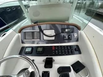 Slide: The Image of 2008 Chris-Craft Catalina 26 dashboard with steering wheel and control panel. - 12