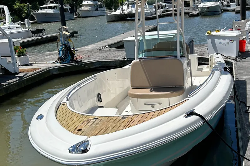 Slide: The Image of 2008 Chris-Craft Catalina 26 boat docked at a marina, showcasing sleek design and wood accents. - 3