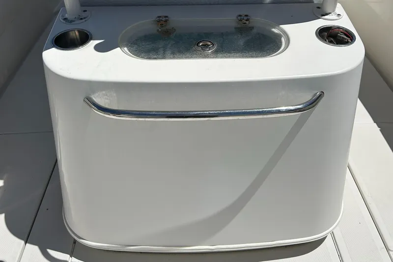 Slide: The Image of 2008 Chris-Craft Catalina 26 boat console with cup holders and storage compartment. - 7
