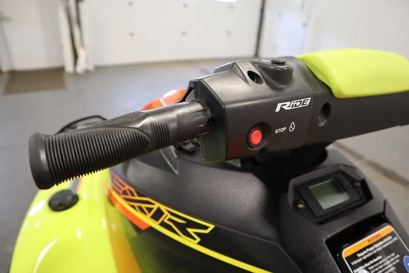 Slide: The Image of 2021 Yamaha WaveRunner EXR® handlebar with control buttons in a garage setting. - 10