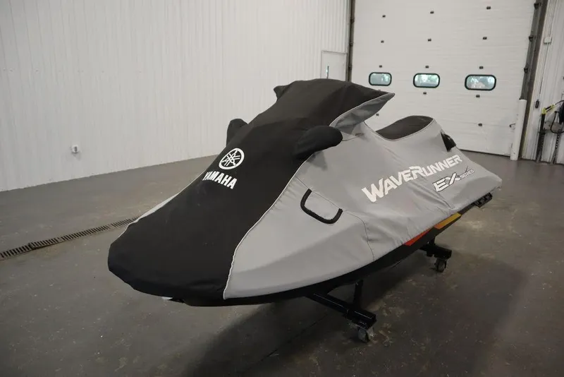 Slide: The Image of 2021 Yamaha WaveRunner EXR® jet ski covered in a protective cover, indoors. - 24