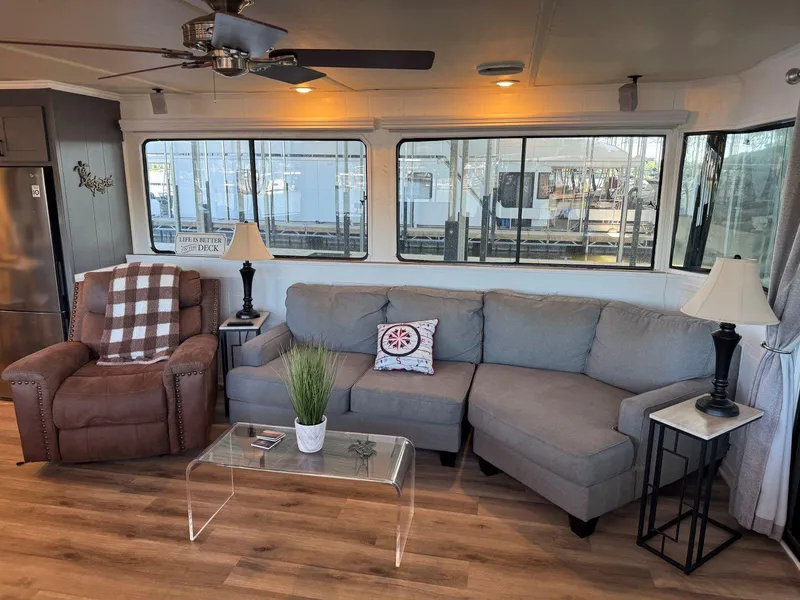 Slide: The Image of Cozy living area in a 1986 Stardust Cruisers 18 X 80 houseboat with modern decor. - 11
