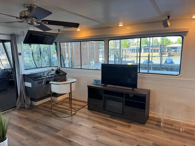 Slide: The Image of Interior of a 1986 Stardust Cruisers 18 X 80 houseboat with modern decor and large windows. - 12