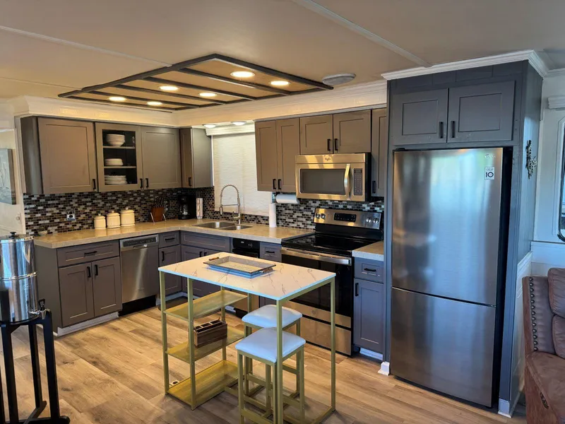 Slide: The Image of Modern kitchen interior on 1986 Stardust Cruisers 18 X 80 houseboat with stainless steel appliances. - 14