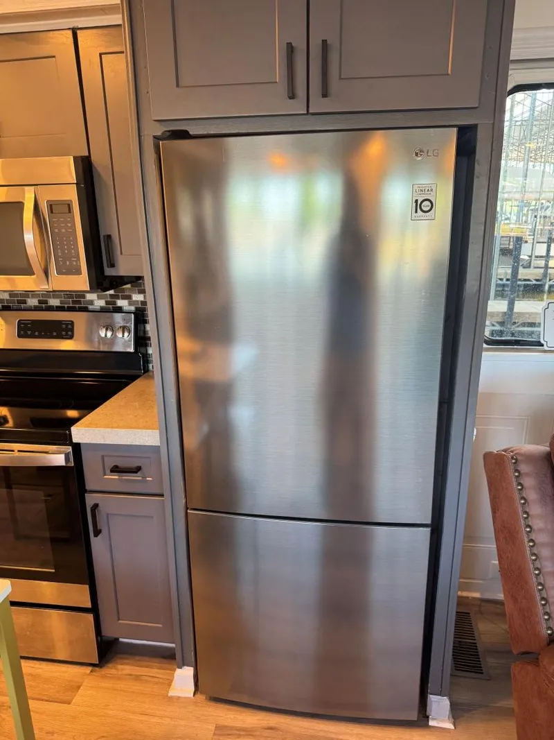 Slide: The Image of Stainless steel refrigerator in a 1986 Stardust Cruisers 18 X 80 houseboat kitchen. - 15