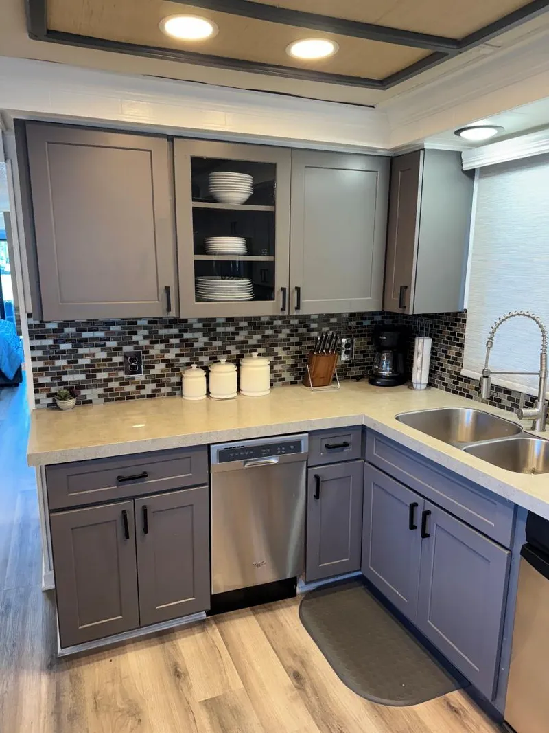 Slide: The Image of Modern kitchen in 1986 Stardust Cruisers 18 X 80 houseboat with gray cabinets and mosaic backsplash. - 17