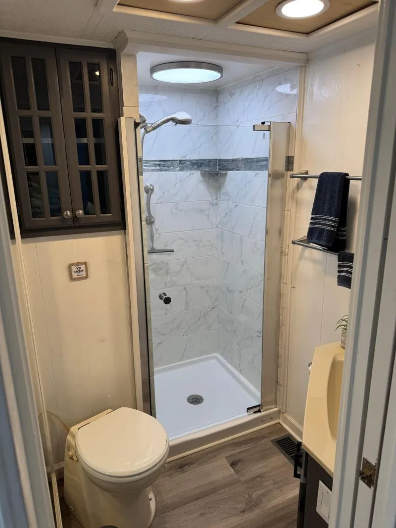 Slide: The Image of Compact bathroom in 1986 Stardust Cruisers houseboat with shower, toilet, and storage cabinet. - 22