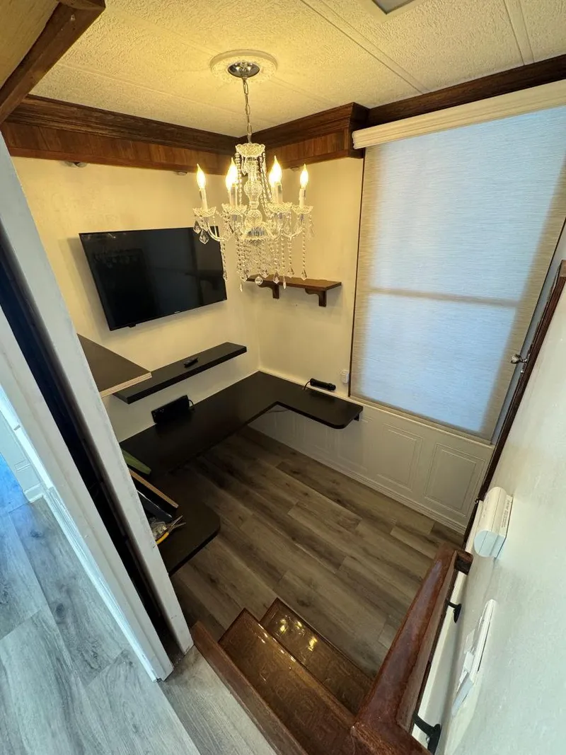 Slide: The Image of 1986 Stardust Cruisers houseboat interior with chandelier, TV, and modern decor. - 26