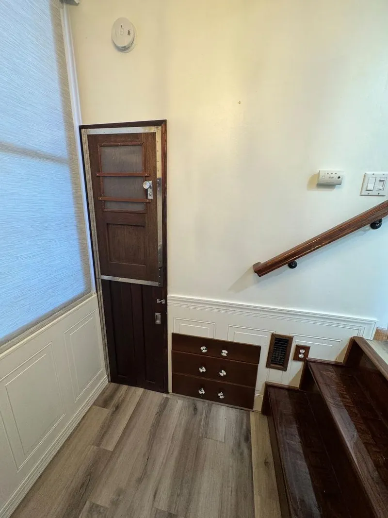 Slide: The Image of 1986 Stardust Cruisers houseboat interior with wooden stairs and small door. - 28