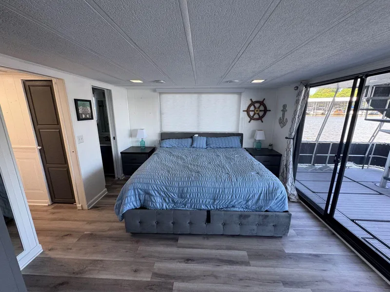 Slide: The Image of Luxurious bedroom in 1986 Stardust Cruisers 18 X 80 houseboat with waterfront view. - 36