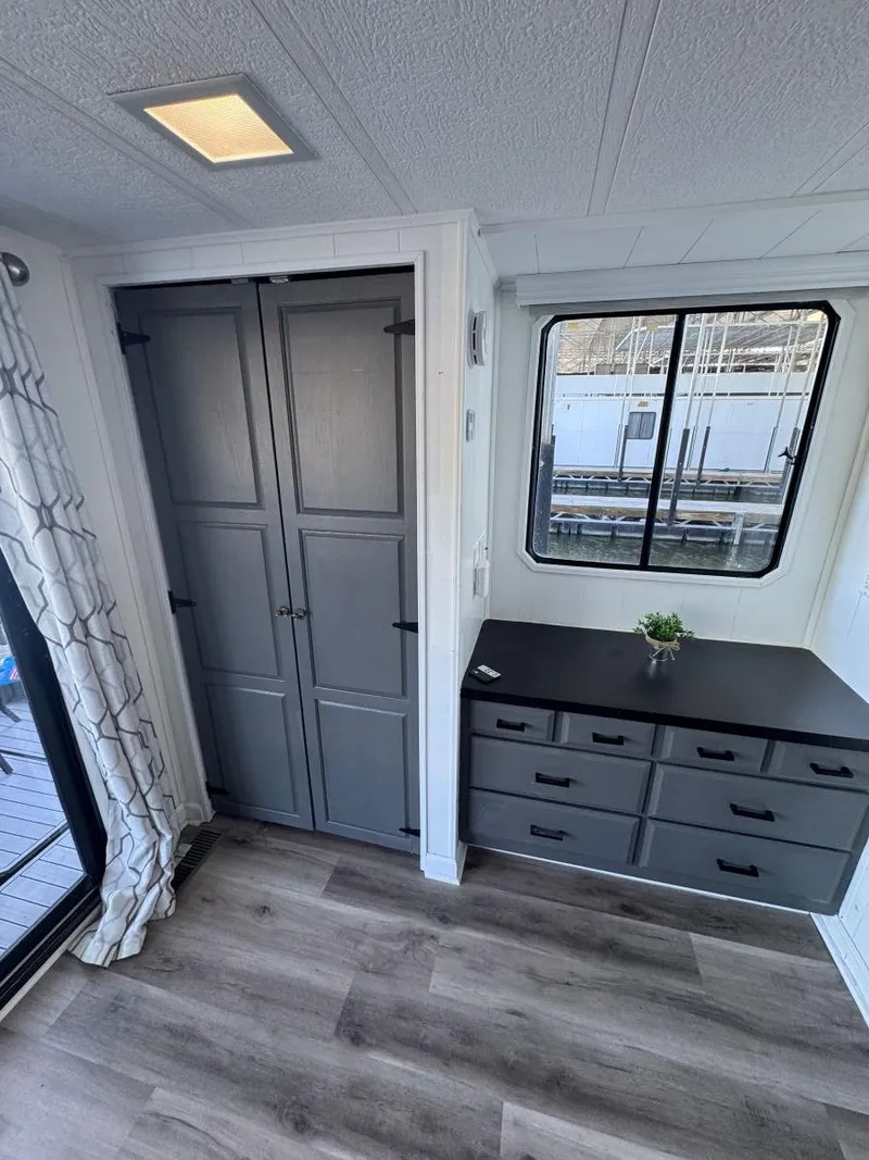 Slide: The Image of 1986 Stardust Cruisers houseboat interior with modern cabinets and window view. - 39