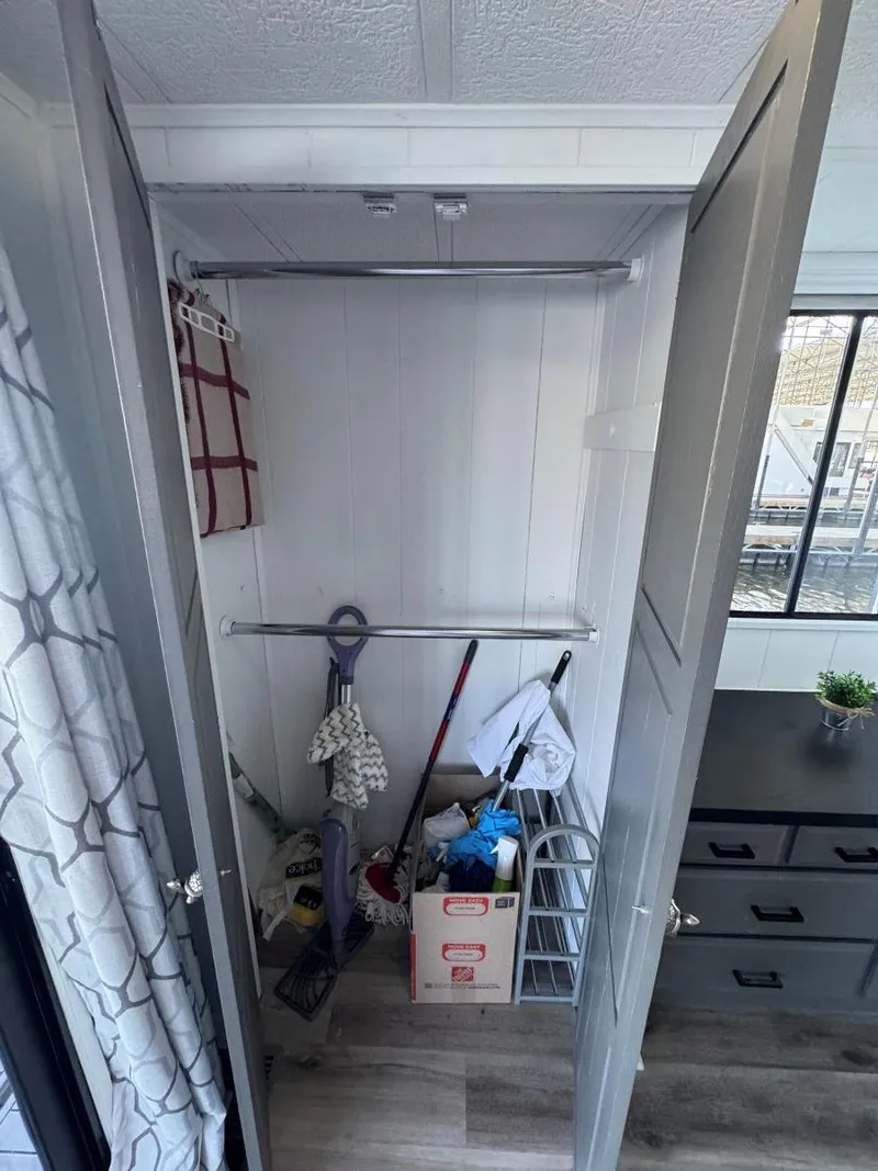 Slide: The Image of Closet interior on 1986 Stardust Cruisers houseboat, featuring cleaning supplies and storage items. - 40