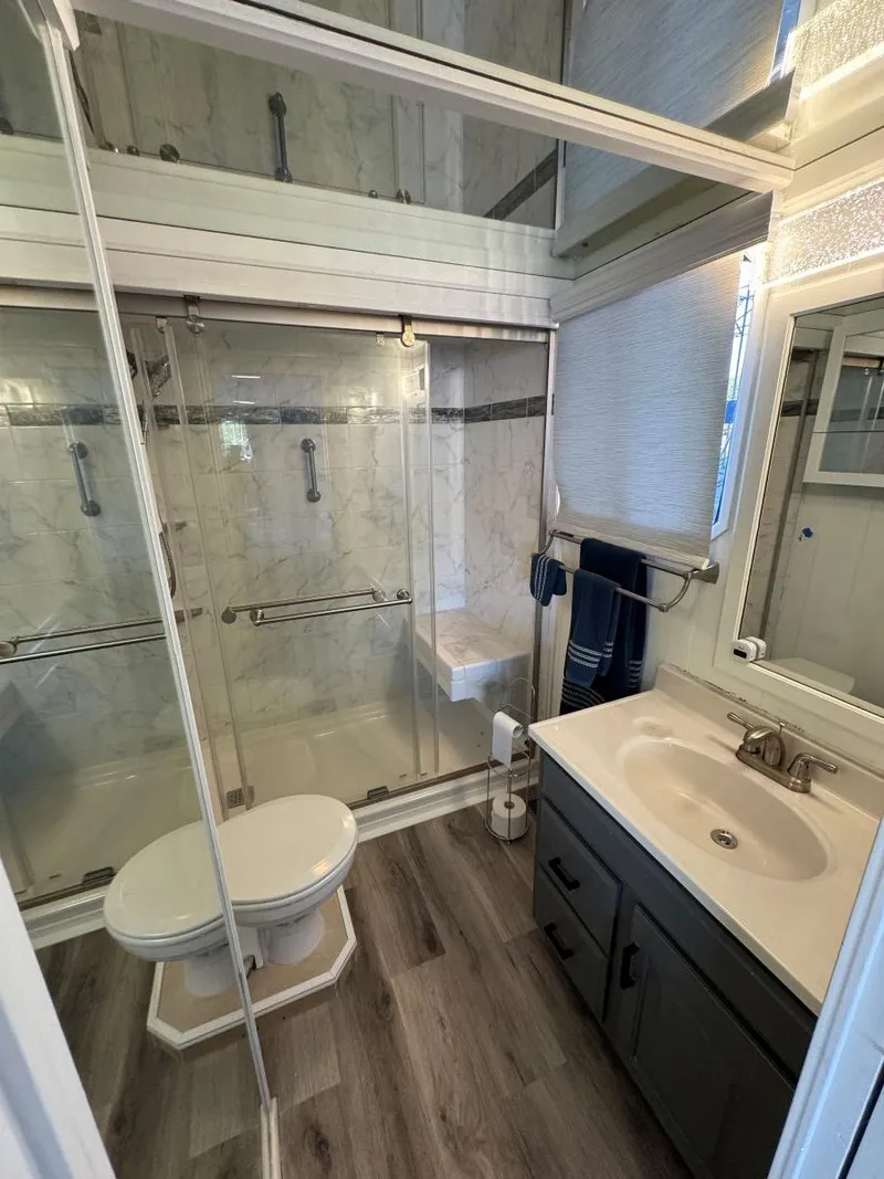 Slide: The Image of Bathroom in 1986 Stardust Cruisers 18 X 80 Houseboat with modern fixtures and glass shower. - 41